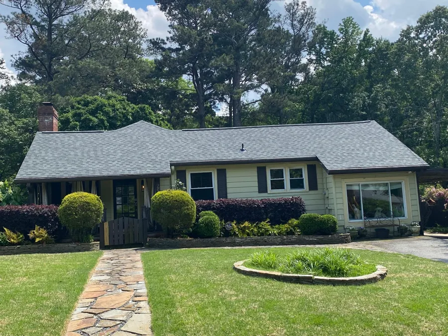 New gray architectural shingle roof on a ranch home with a stone front walk